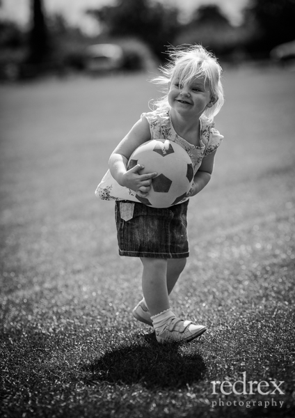 Toddler with football in the park