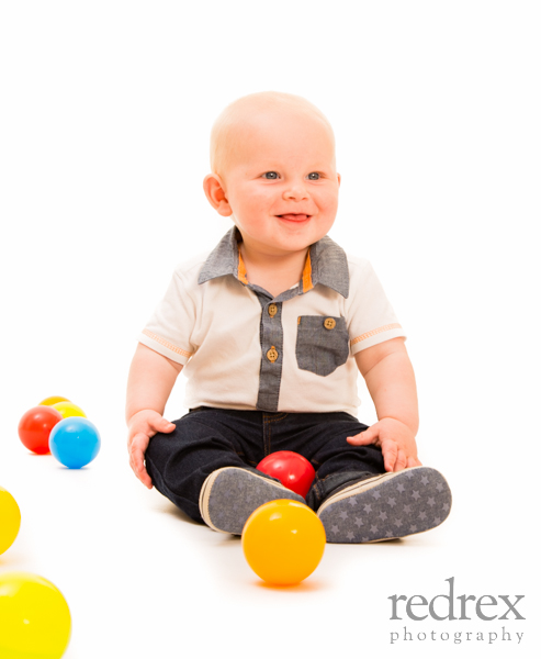 baby playing with colourful balls
