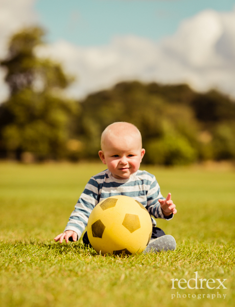 Baby with football in the park